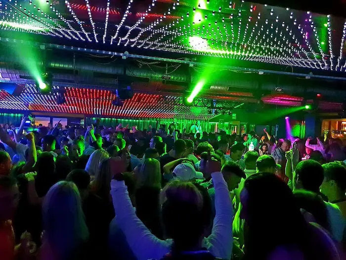 Inside Pietas Julia Nightclub Pula featuring neon laser light shows, DJ performance and crowded dance floor